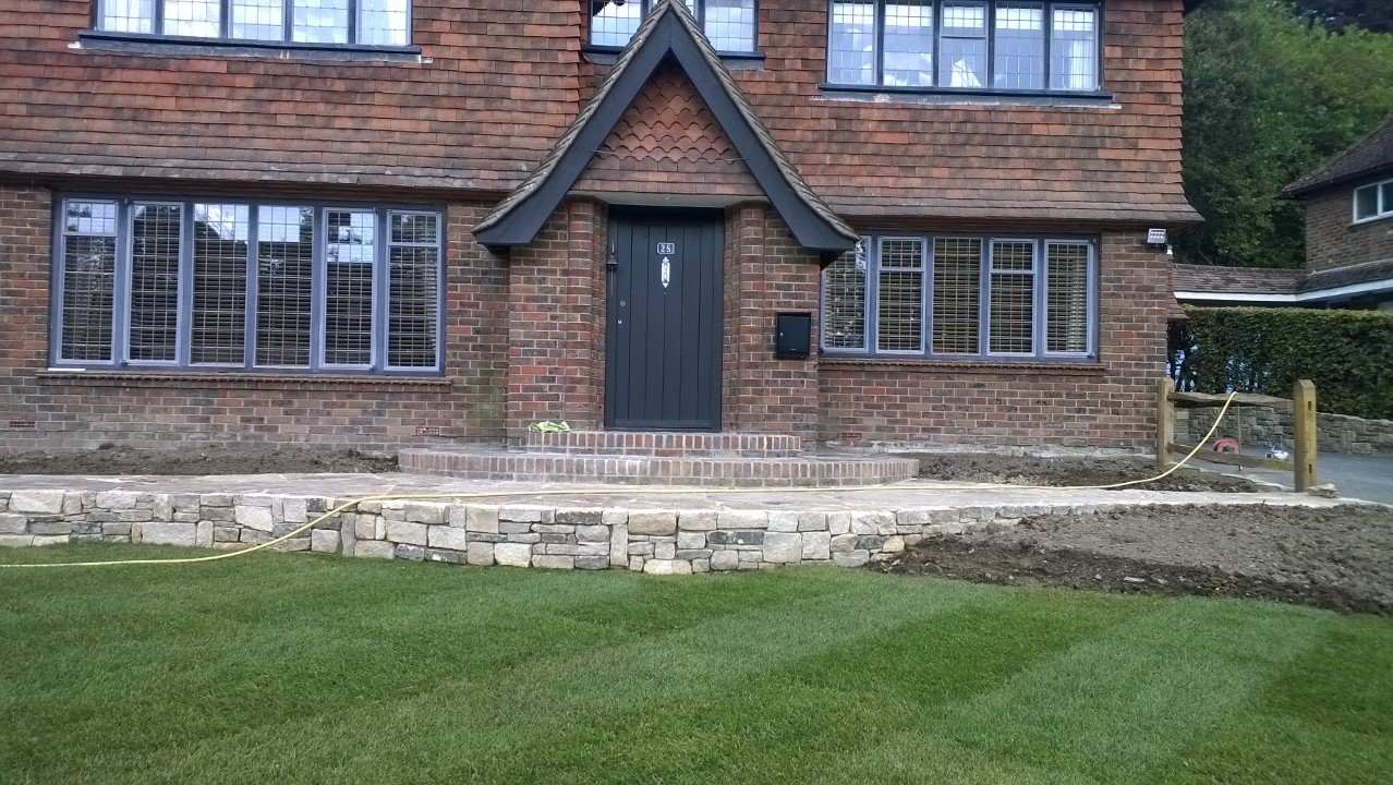 Stone-faced retaining wall, pathway and lawn in Haslemere
